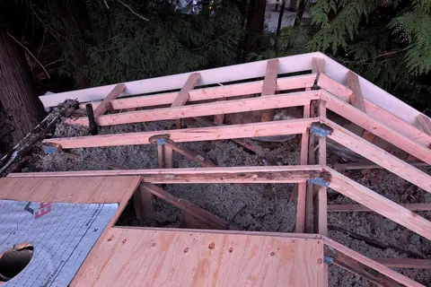 New plywood sheathing installed over the rebuilt deck on the same Port Orchard roof